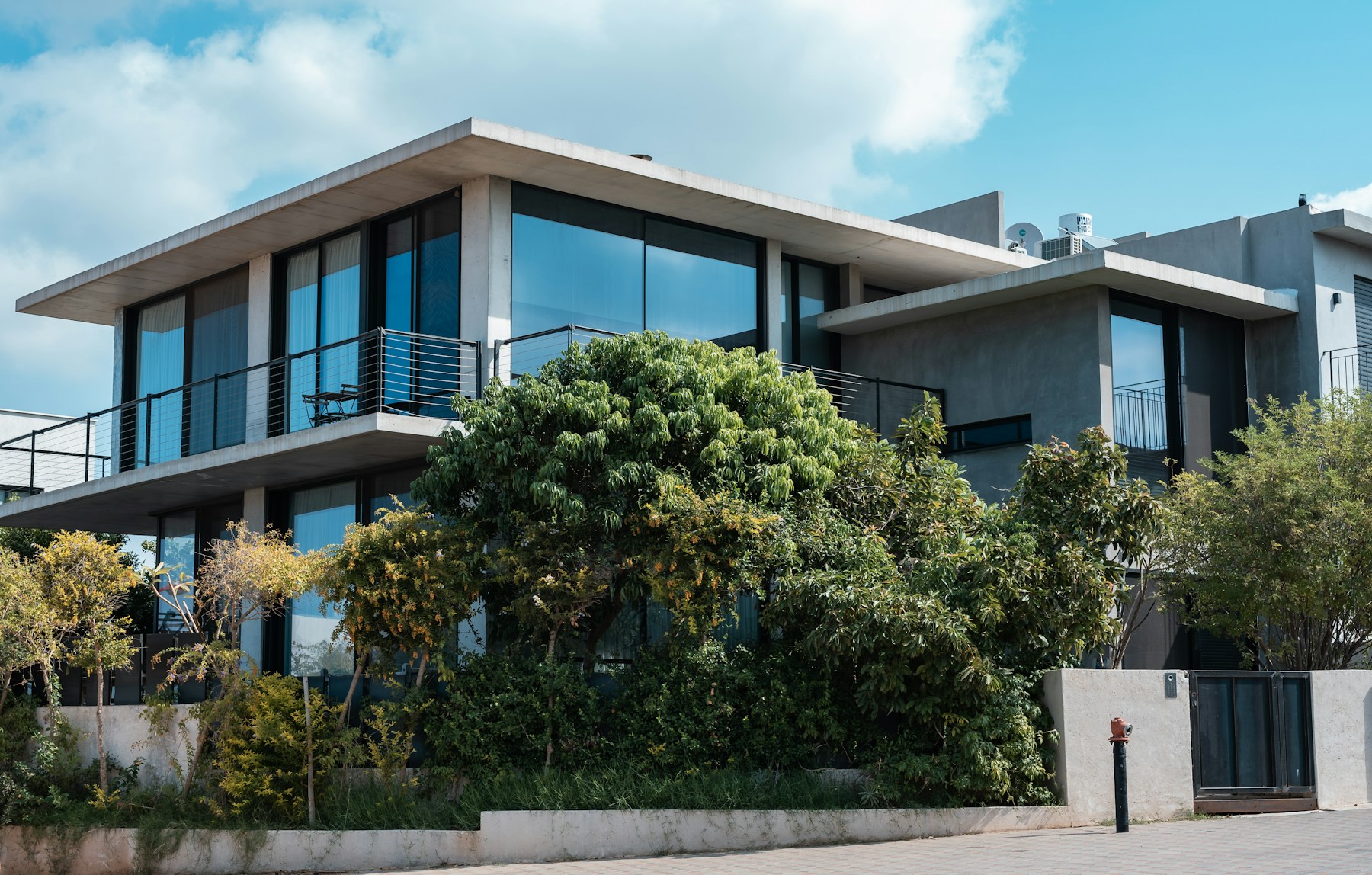Concrete, glass, and greenery framing a contemporary home